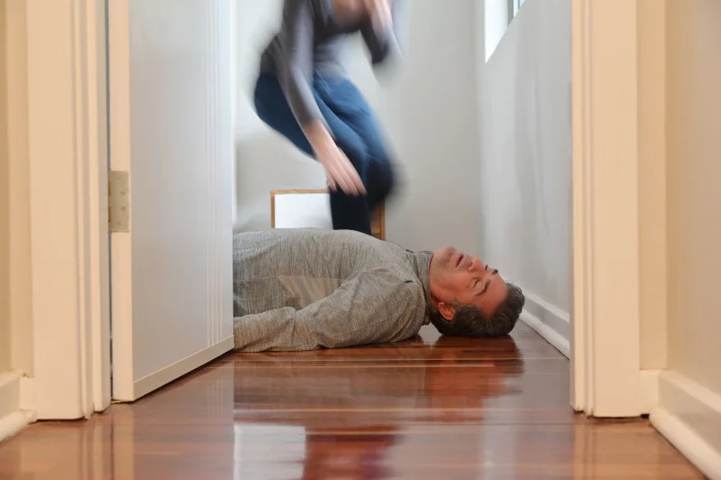 Person responding to a suspected fentanyl overdose, showing emergency action during an opioid overdose situation