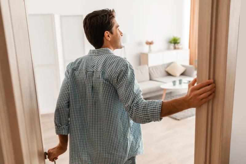 Person entering a home environment representing the difference between inpatient rehab and outpatient rehab for addiction treatment and recovery.