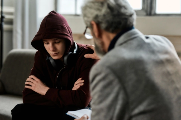 Healthcare professional providing support to an individual seeking treatment for DXM withdrawal and dextromethorphan addiction