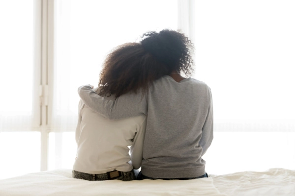 Two people embracing while providing emotional support during DXM withdrawal and addiction recovery