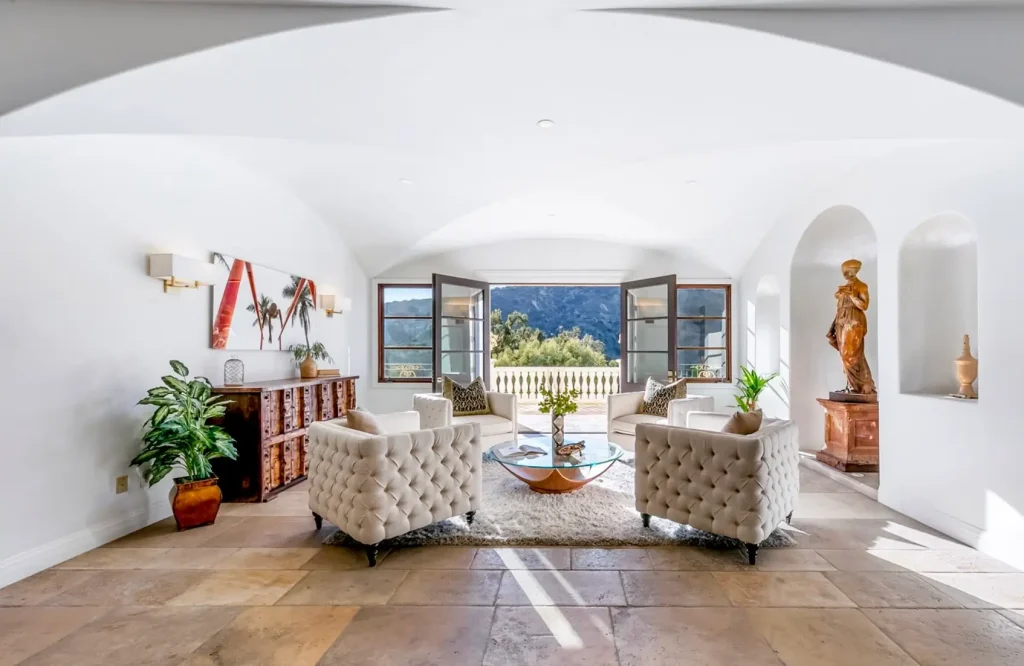 Luxury depression rehab retreat interior featuring elegant seating, natural light, open terrace view, and serene mountain surroundings for mental health recovery
