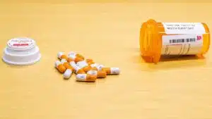Prescription medication bottle and capsules representing Adderall alternatives for ADHD treatment, including stimulant and non-stimulant medication options.