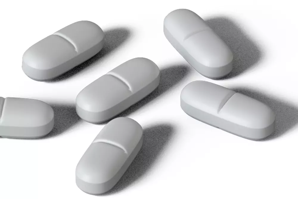 White Xanax bar tablets representing benzodiazepine medication used for anxiety treatment and associated addiction risks.